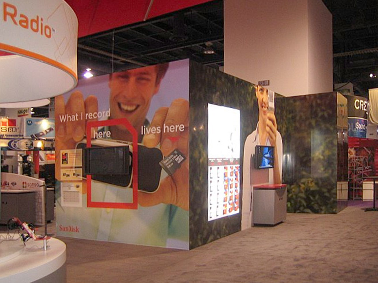 Large advertisement for flash cards showing man holding camera